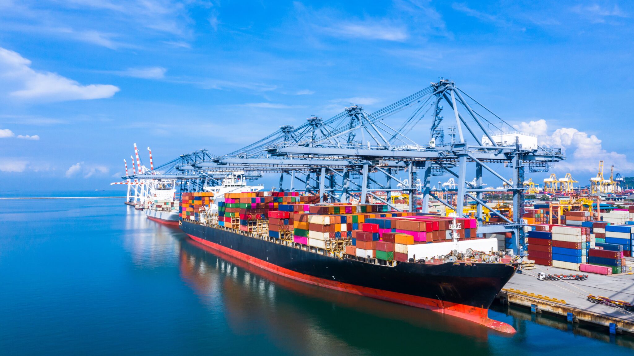 container-ship-arriving-commercial-port-min-2048x1151